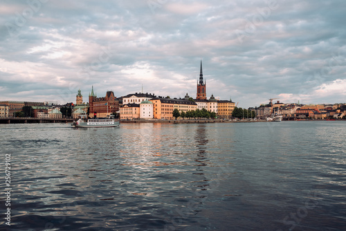 View of Stockholm, Riddarholmen island and Riddarholmen church from the water in cloudy weather.