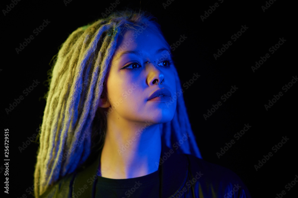 beautiful girl in the light of neon colored lamps light yellow blue on black background beautiful girl in the light of neon colored lamps light yellow blue on black background