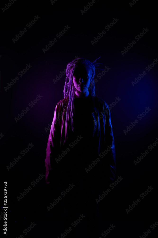 beautiful girl in the light of neon colored lamps light blue purple contours, girl silhouette. on black background