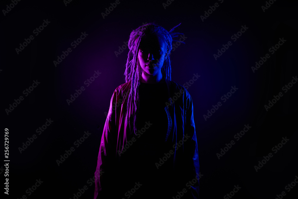 beautiful girl in the light of neon colored lamps light purple contours, girl silhouette. on black background beautiful girl in the light of neon colored lamps light purple contours, girl silhouette. on black background