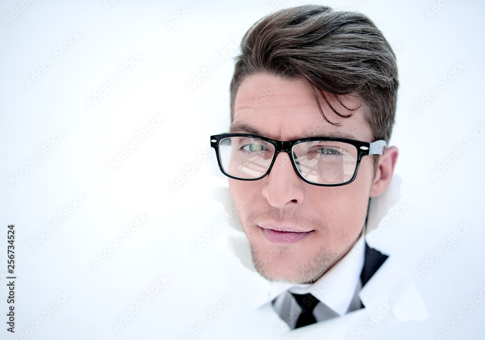 young businessman breaking through a paper wall young businessman breaking through a paper wall