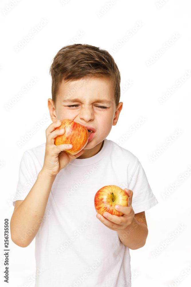 Little boy is eating apple with toothache Little boy is eating apple with toothache