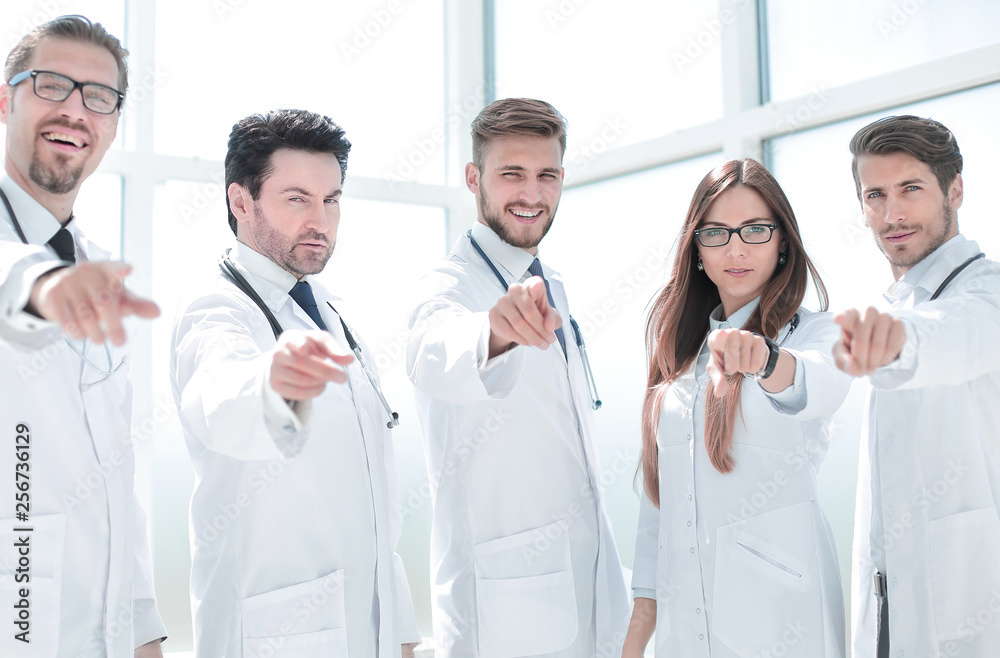 group of practicing doctors pointing their finger at you group of practicing doctors pointing their finger at you