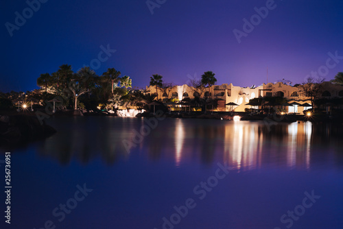 Coast beach of the city at night on a long exposure with the bright lights. © indigo_nifght