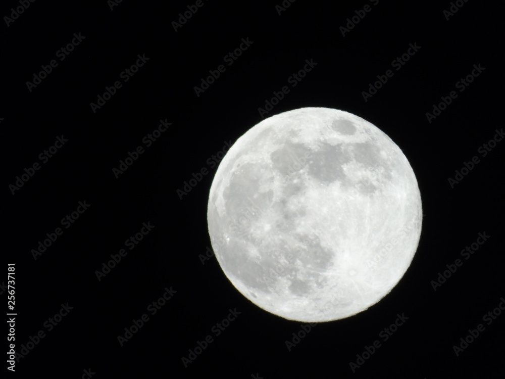 Genova, Italy - 03/20/2019: An amazing photography of the full moon over the city of Genova by night with a great clear sky in background and some stars Genova, Italy - 03/20/2019: An amazing photography of the full moon over the city of Genova by night with a great clear sky in background and some stars