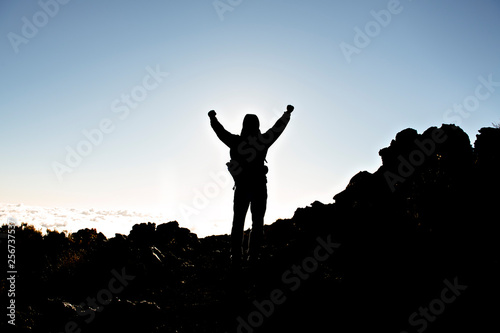 A Man on peak of mountain with arm high