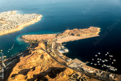 Top view of part of the island with buildings, hotels among the blue sea photo