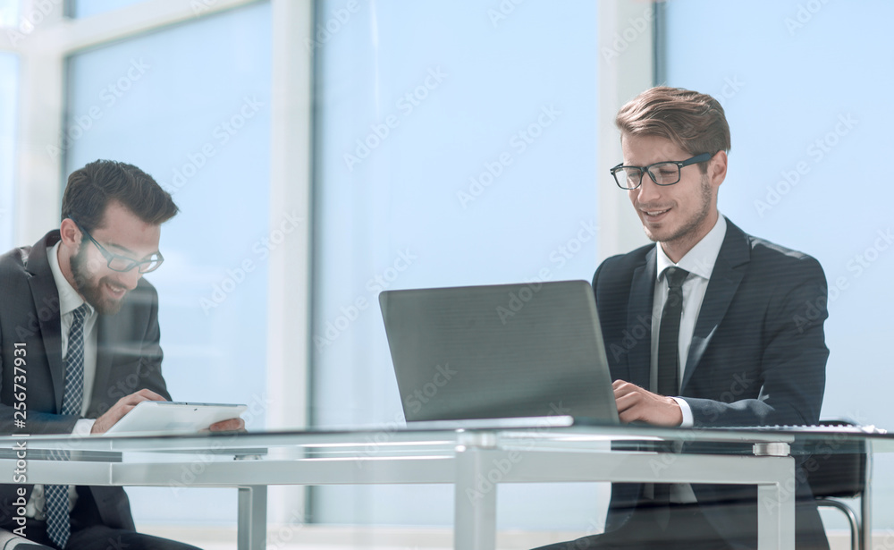 two business people talking sitting at a Desk two business people talking sitting at a Desk