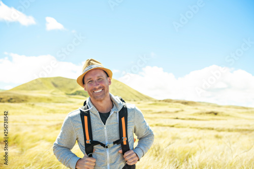 The Successful man mountain hiker with backpack traveler caucasian