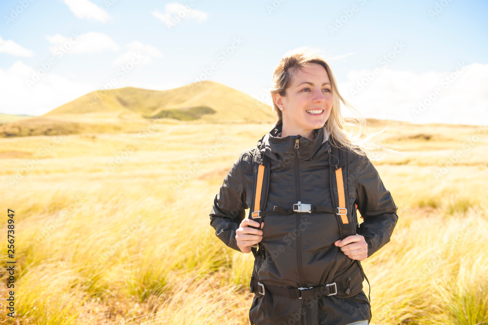 The Successful woman mountain hiker with backpack traveler caucasian