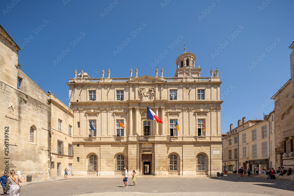 Tourists and locals  in front of the town hall in the Place de la Republique, the main square in Arles, France