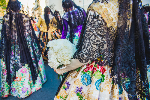 Detail of the traditional Spanish Valencian Fallera dress, colorful fabrics with intricate embroidery.