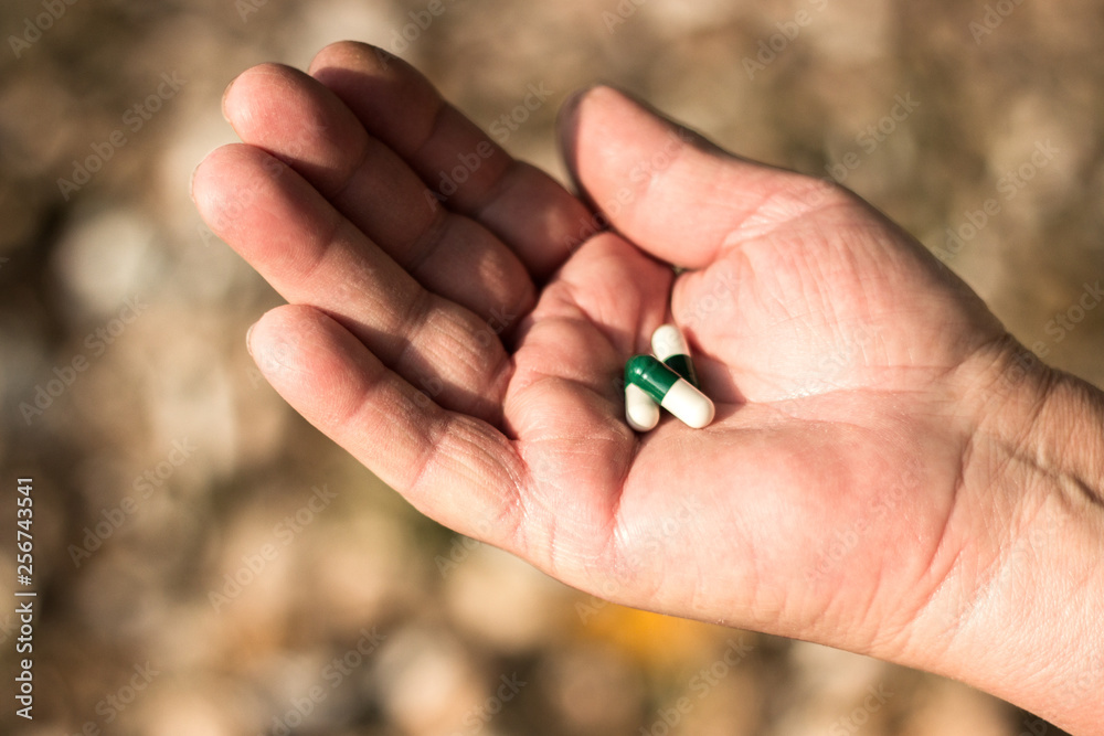 Medication in senior hand