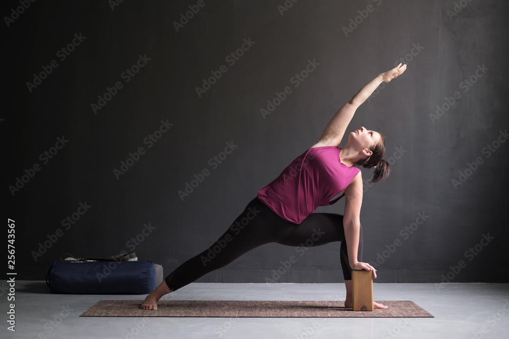 woman doing Extended Side Angle posture, Utthita Parsva Konasana.