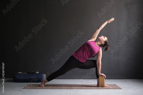 woman doing Extended Side Angle posture, Utthita Parsva Konasana. photo