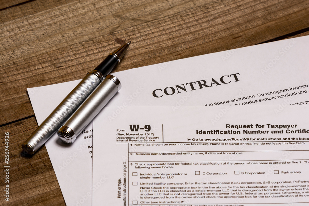 IRS form W9 and a contract Stock Photo Adobe Stock