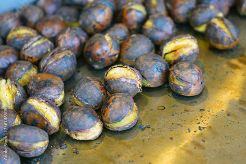 Roasted chestnuts in a blue pan for sale in the street in Kyoto