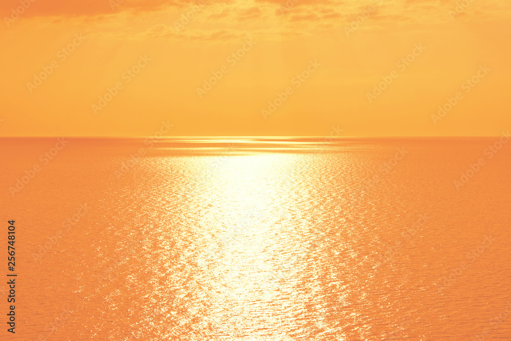 Orange sunset over Mediterranean Sea. Beautiful sunset over calm ocean. Sunrise or sunset over the sea with retro filter effect, summer concept