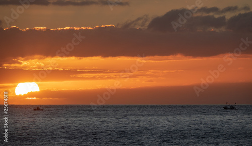 Sunset over the ocean with two small fishing boats © F.C.G.