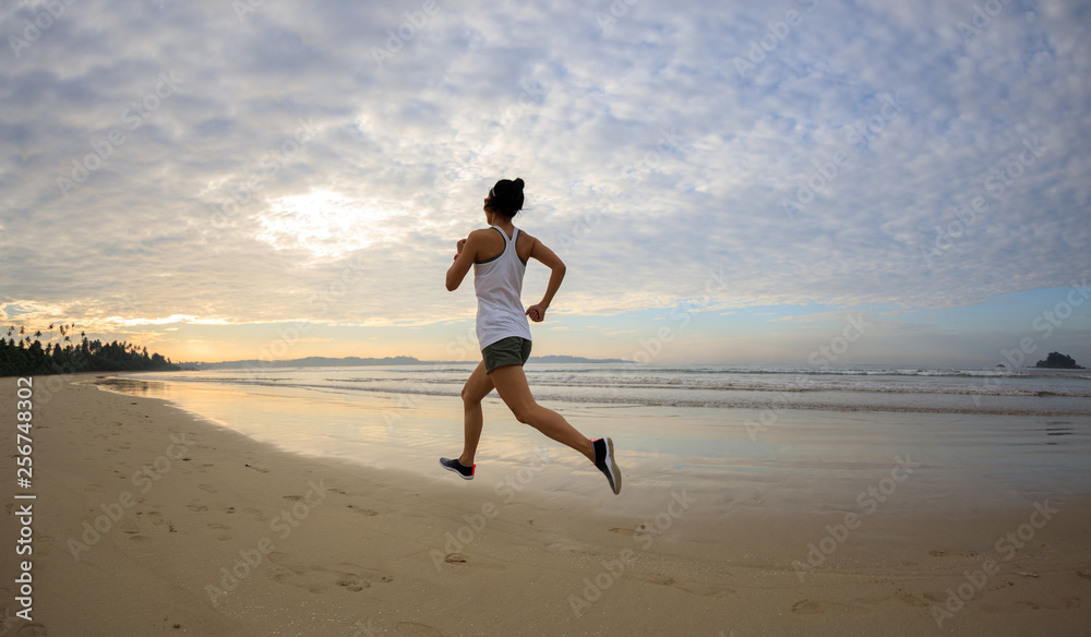 young fitness woman running at sunrise beach young fitness woman running at sunrise beach