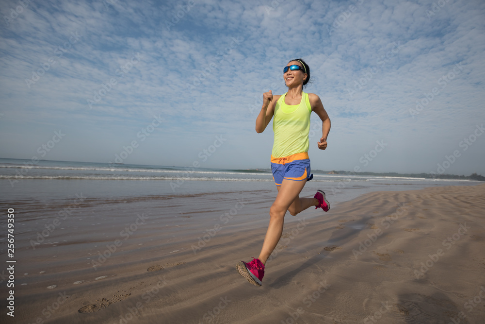 young fitness woman running at sunrise beach young fitness woman running at sunrise beach