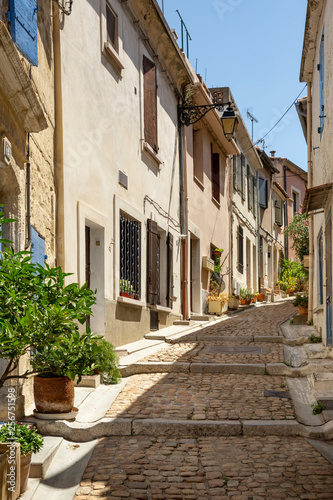 Narrow cobblestone street opposite the Arles amphitheatre  France