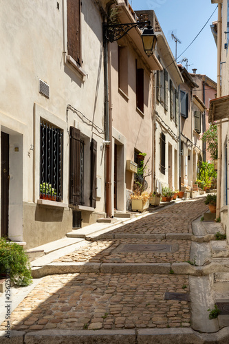 Narrow cobblestone street opposite the Arles amphitheatre, France