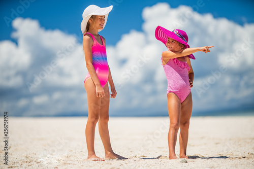 Happy kids travel on a white san tropical ocean beach resort photo