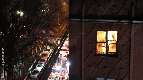 Close Up View of a Massive Apartment Fire Through a Window at Night