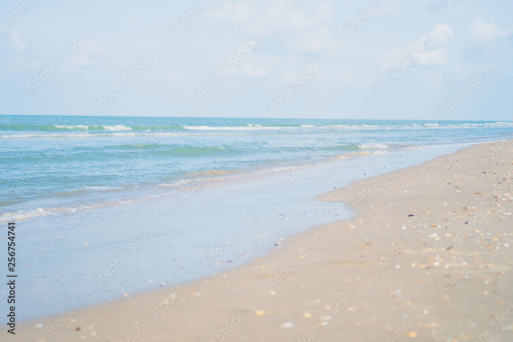 Tropical nature clean beach and white sand in summer with sun light blue sky and bokeh background.