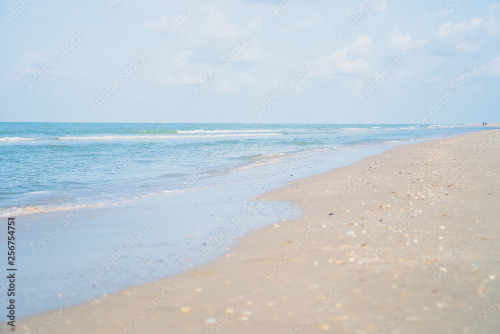 Tropical nature clean beach and white sand in summer with sun light blue sky and bokeh background.