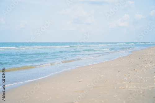 Tropical nature clean beach and white sand in summer with sun light blue sky and bokeh background.