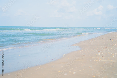 Tropical nature clean beach and white sand in summer with sun light blue sky and bokeh background.