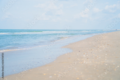 Tropical nature clean beach and white sand in summer with sun light blue sky and bokeh background.