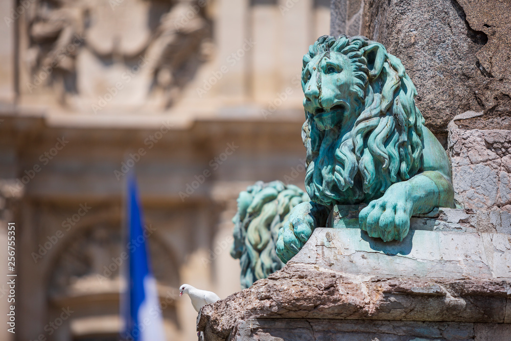Fototapeta premium Arles France July 12th 2015 : Bronze lions on the 'Needle of Arles' obelisk in the main square in Arles, France
