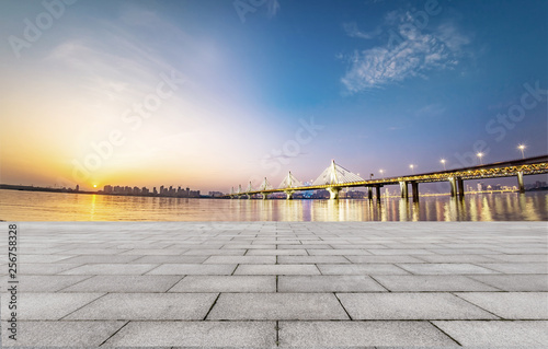 empty brick floor and cityscape of modern city near