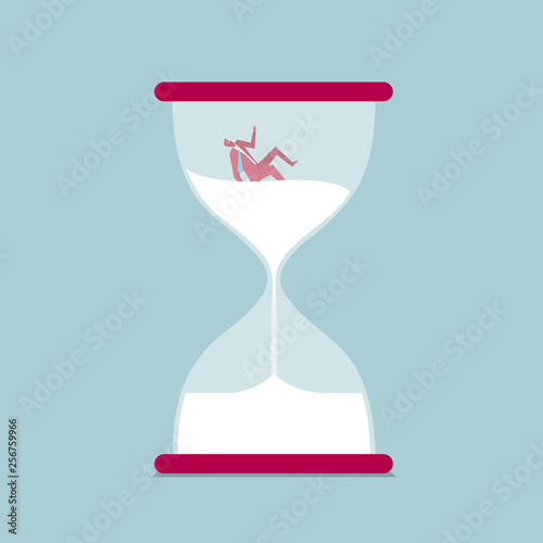 The businessman fell in the hourglass. Isolated on blue background.