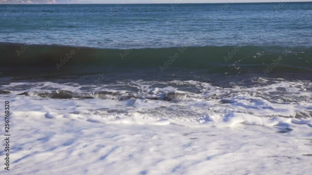 Big breaking sea wave on a beach in sunny day slow motion Big breaking sea wave on a beach in sunny day slow motion