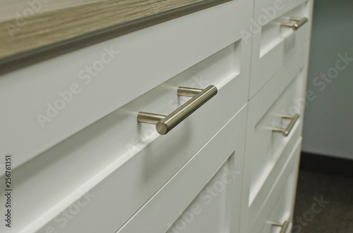 The front of the white drawer on the craft organizer. 