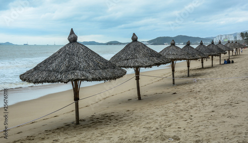 Sand beach with wooden umbrellas