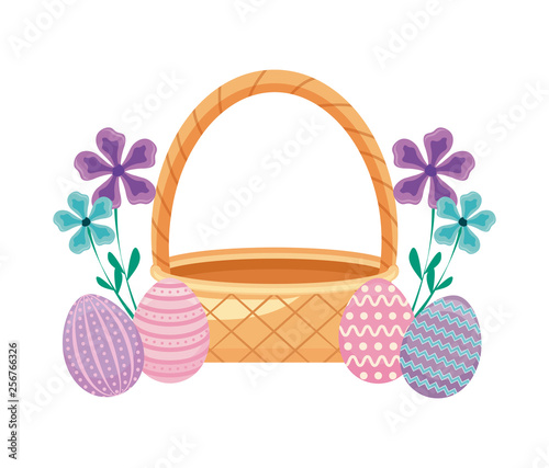 basket wicker with eggs of easter and flowers