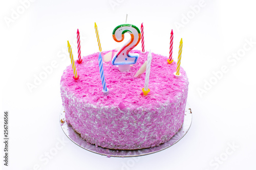 birtday cake with burning candle number 2 (two) two year old birtday pink cake on white background