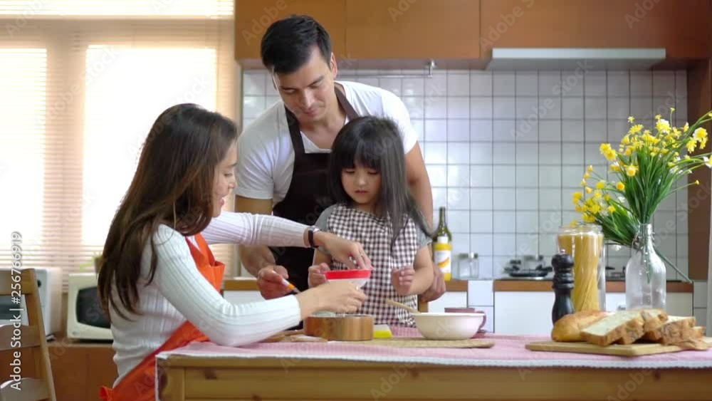 Happy Asian family cooking in kitchen, with happy and smile, lifestyle happy family concept Happy Asian family cooking in kitchen, with happy and smile, lifestyle happy family concept