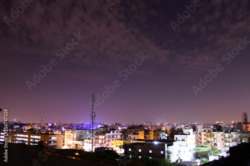 Evening cityscape with blue light haze and fast moving clouds