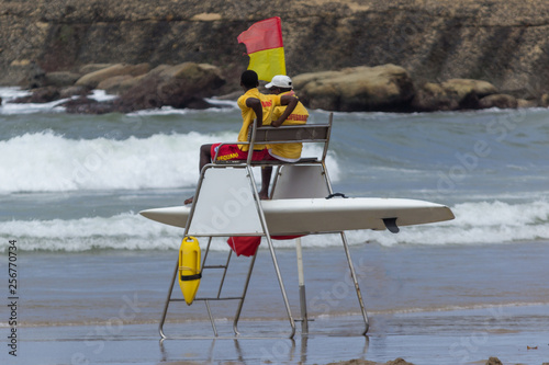 African life guards sitting on a high chair on the beach