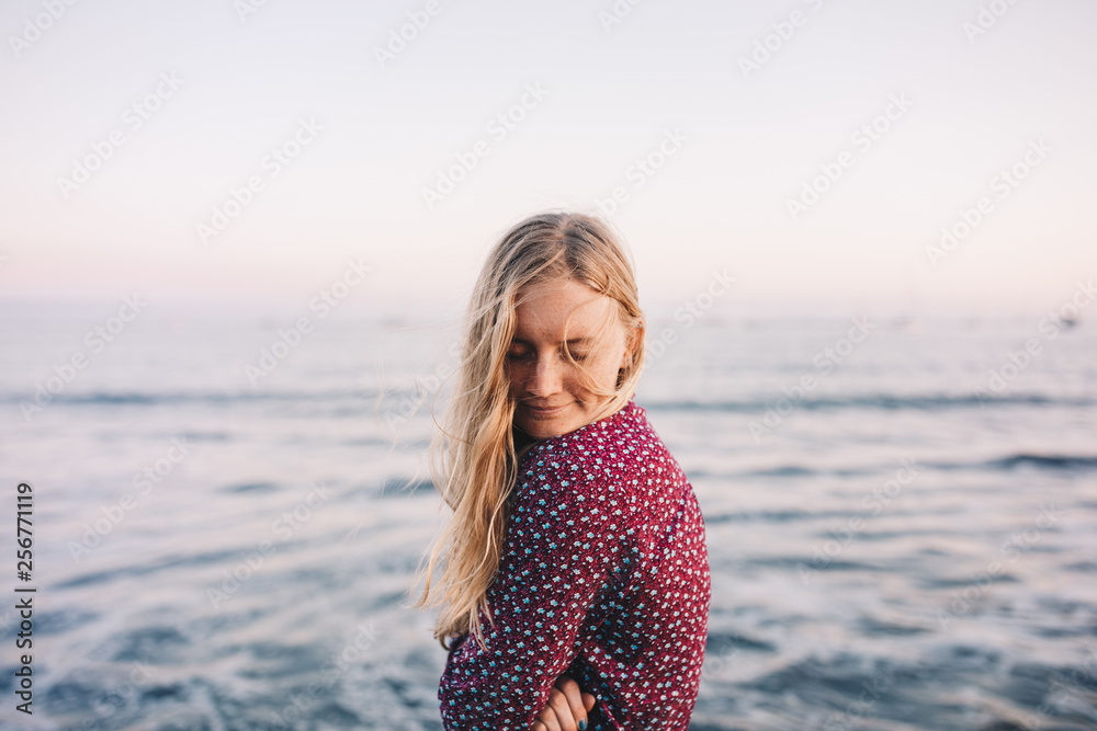 Blonde woman at beach and sunset