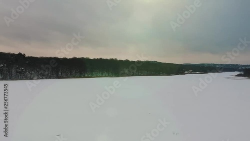 drone flying over trees to show us a frozen lake. photo