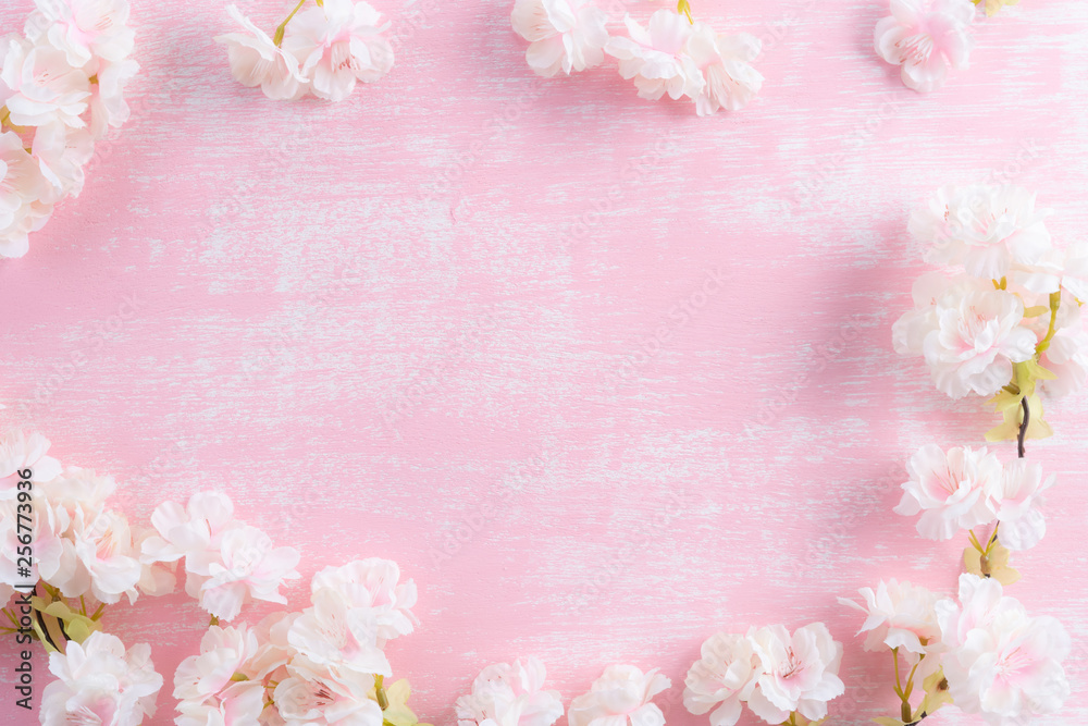 Spring background. Spring blooming branches on pink wooden background. Apple blossoms.