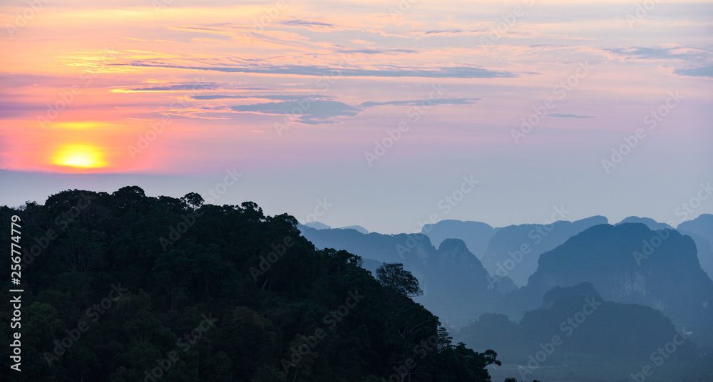 Stunning sunset behind some beautiful limestone mountains. Picture taken from the Tiger Cave Temple (Wat Tham Sua) Krabi, Thailand. Stunning sunset behind some beautiful limestone mountains. Picture taken from the Tiger Cave Temple (Wat Tham Sua) Krabi, Thailand.