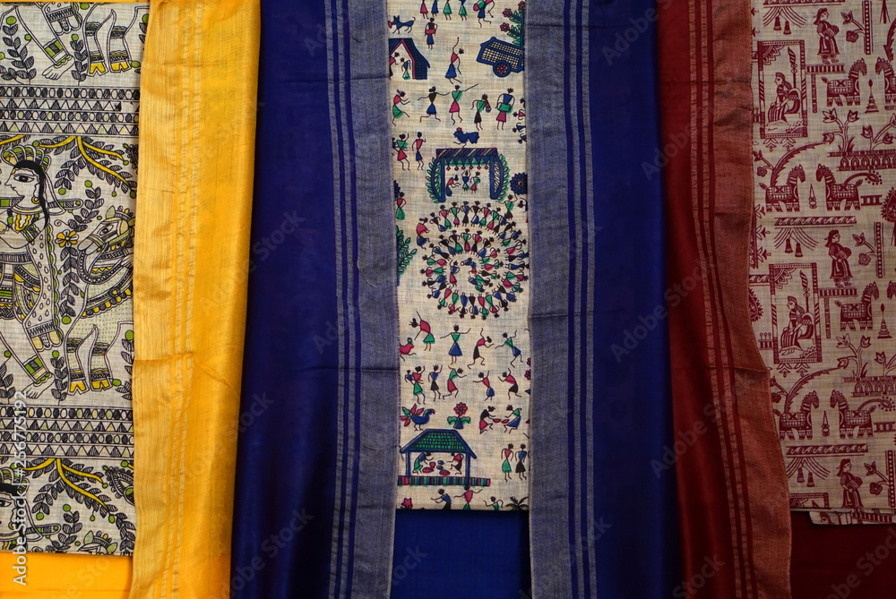 Indian woman traditional hand loom salwar kameez or punjabi dress kept in display of retail clothes shop Indian woman traditional hand loom salwar kameez or punjabi dress kept in display of retail clothes shop